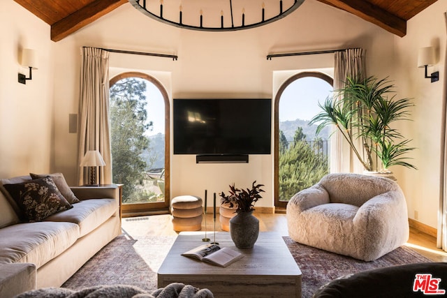 living room featuring vaulted ceiling with beams, hardwood / wood-style floors, and wood ceiling