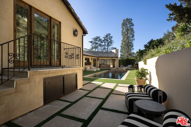 view of swimming pool with a patio