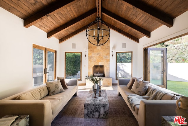 living room with beamed ceiling, wooden ceiling, and an inviting chandelier