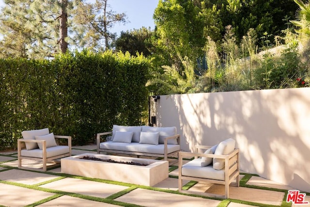 view of patio / terrace with an outdoor living space with a fire pit