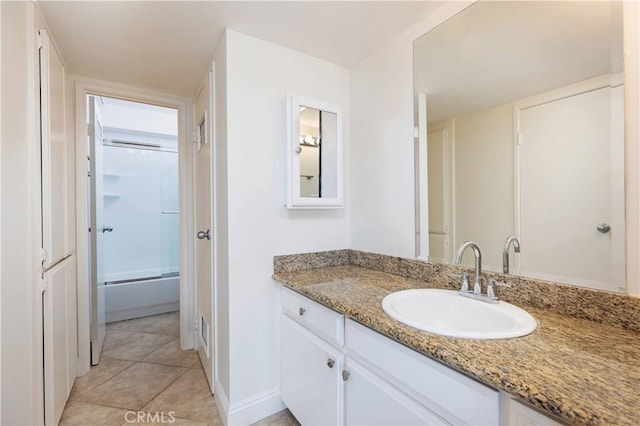 bathroom with tile patterned flooring, vanity, and shower / bath combination with glass door