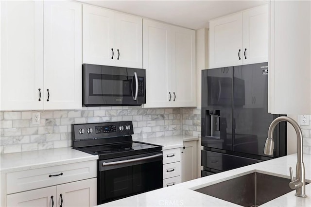 kitchen with fridge with ice dispenser, white cabinetry, range with electric cooktop, sink, and tasteful backsplash