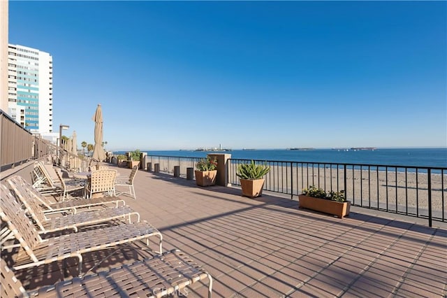 view of patio / terrace featuring a view of the beach and a water view