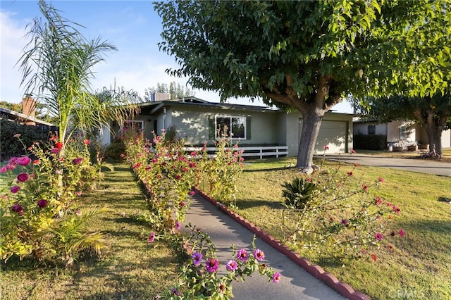 single story home featuring a garage and a front yard