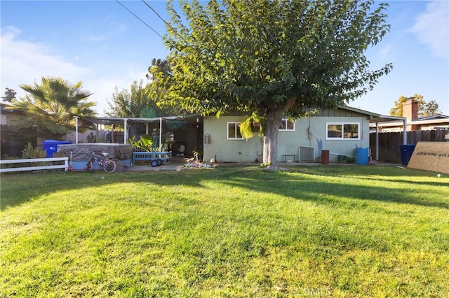 back of house with a yard