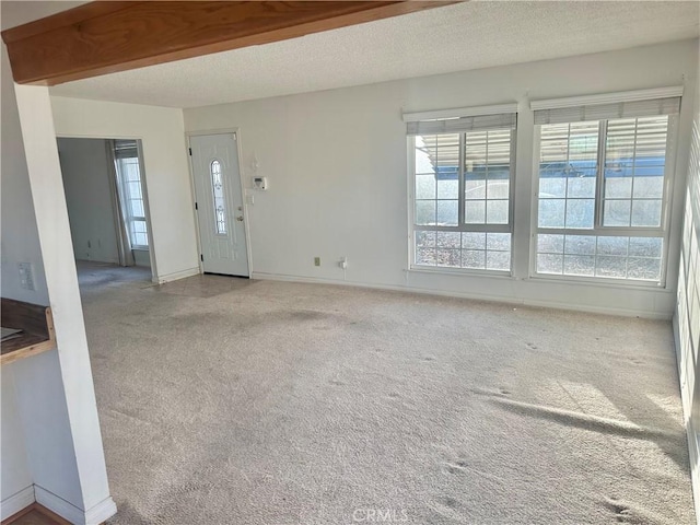 401 Fenmore Dr, Barstow, CA 92311 - entryway featuring carpet, healthy amount of natural light, and a textured ceiling