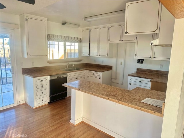 kitchen with white cabinetry, dishwasher, and hardwood / wood-style flooring