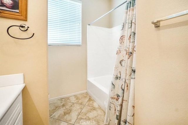 bathroom featuring tile patterned flooring, vanity, and shower / bathtub combination with curtain