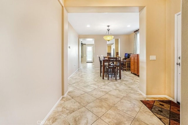 hall with light tile patterned floors