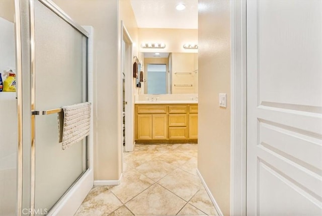 bathroom with tile patterned flooring, vanity, and an enclosed shower