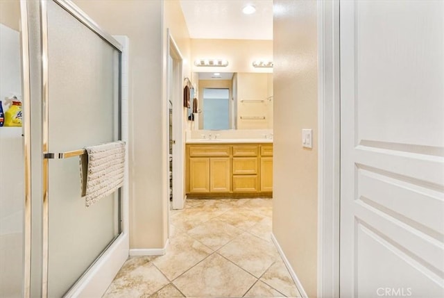 bathroom with tile patterned floors, vanity, and a shower with shower door