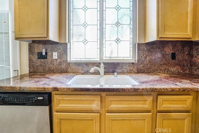 kitchen featuring decorative backsplash, stainless steel dishwasher, light stone countertops, and sink