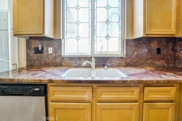 kitchen with sink, backsplash, light stone countertops, and dishwasher