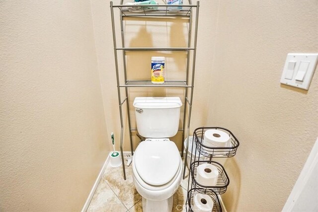 bathroom with tile patterned flooring and toilet