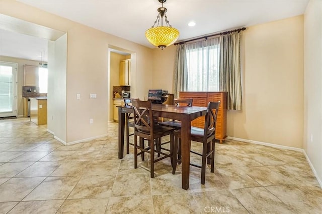 dining space featuring light tile patterned floors