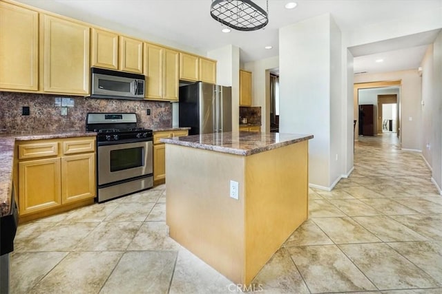 kitchen featuring light tile patterned flooring, dark stone countertops, backsplash, a center island, and stainless steel appliances