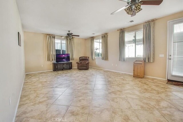 interior space featuring ceiling fan, light tile patterned floors, and a healthy amount of sunlight