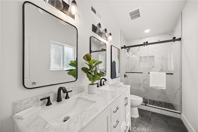 bathroom with vanity, a shower with shower door, and toilet