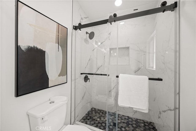 bathroom featuring an enclosed shower and toilet