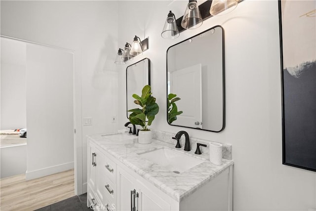 bathroom with vanity and hardwood / wood-style flooring