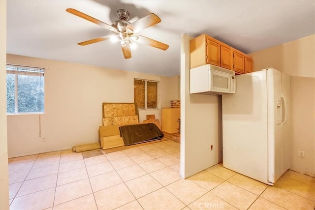 kitchen with ceiling fan, white appliances, and light tile patterned floors