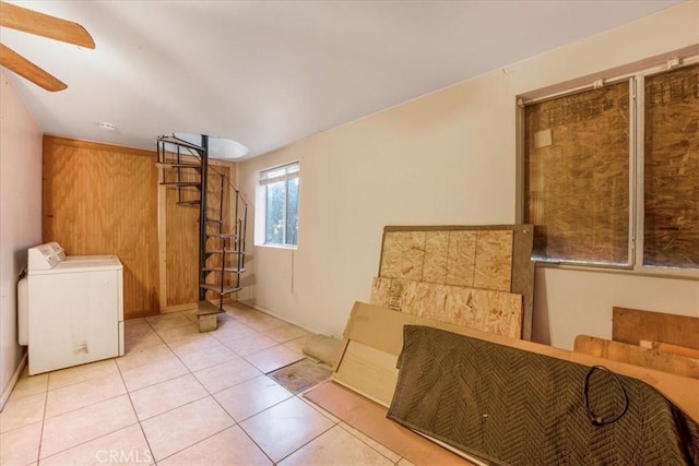 interior space with washer / clothes dryer, ceiling fan, and light tile patterned flooring