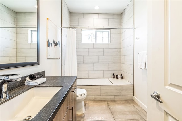 full bathroom featuring tile patterned flooring, vanity, toilet, and shower / bath combo with shower curtain