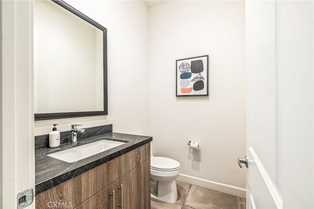 bathroom featuring tile patterned floors, vanity, and toilet