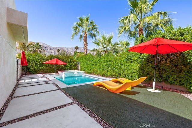 view of pool with a mountain view, an in ground hot tub, and a patio