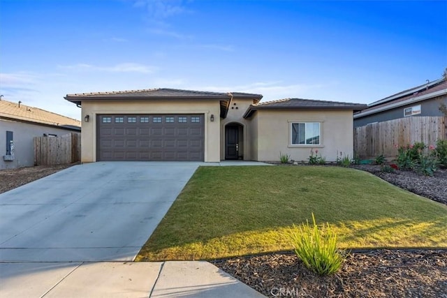 view of front of house featuring a garage and a front yard