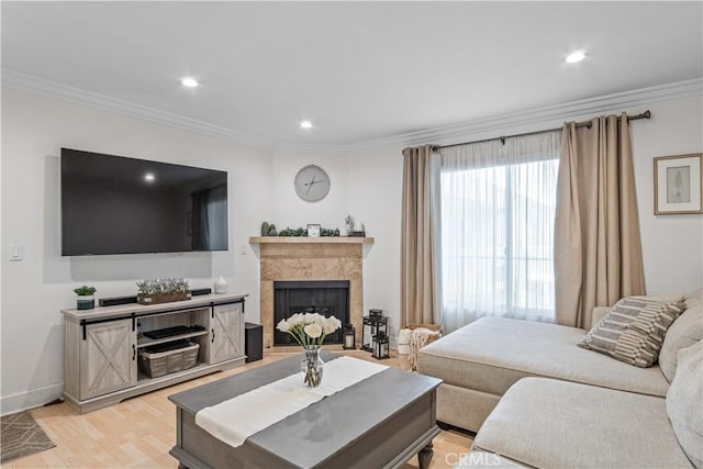 living room with crown molding and light hardwood / wood-style flooring