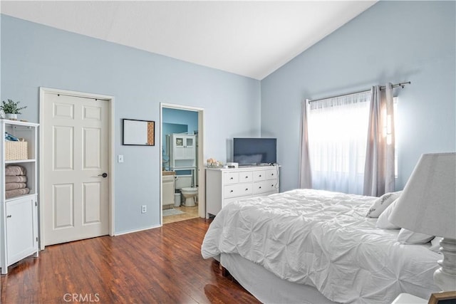 bedroom featuring ensuite bathroom, dark hardwood / wood-style flooring, and vaulted ceiling