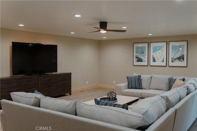 living room featuring ceiling fan and light wood-type flooring