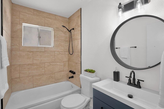 full bathroom featuring tiled shower / bath, vanity, and toilet