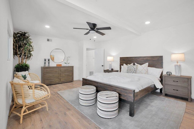 bedroom with beamed ceiling, light hardwood / wood-style floors, and ceiling fan