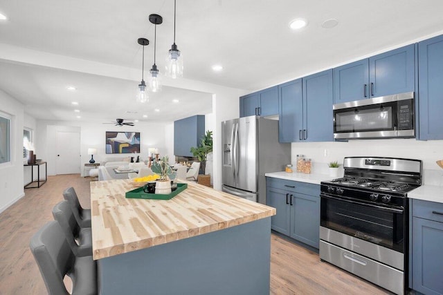 kitchen with light wood-type flooring, stainless steel appliances, and blue cabinets