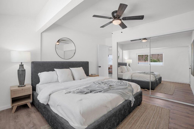 bedroom with hardwood / wood-style floors, ceiling fan, and a closet