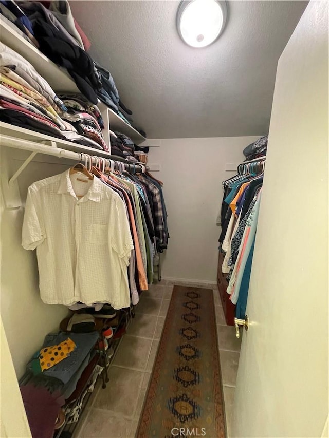 walk in closet featuring tile patterned flooring