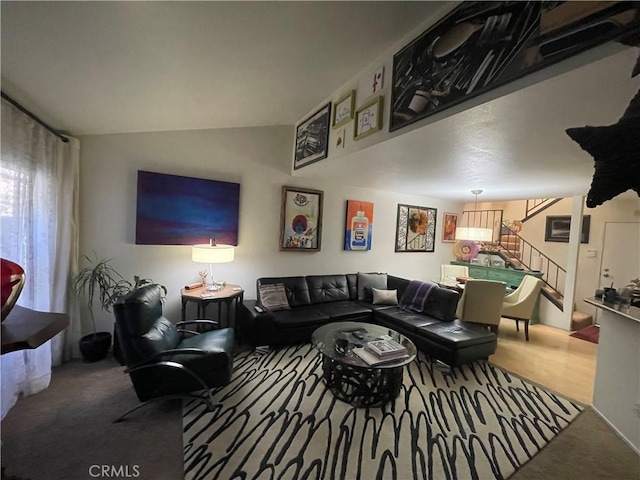 living room featuring carpet flooring and vaulted ceiling