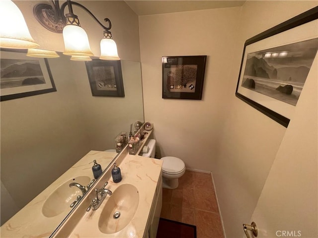 bathroom featuring tile patterned flooring, vanity, and toilet