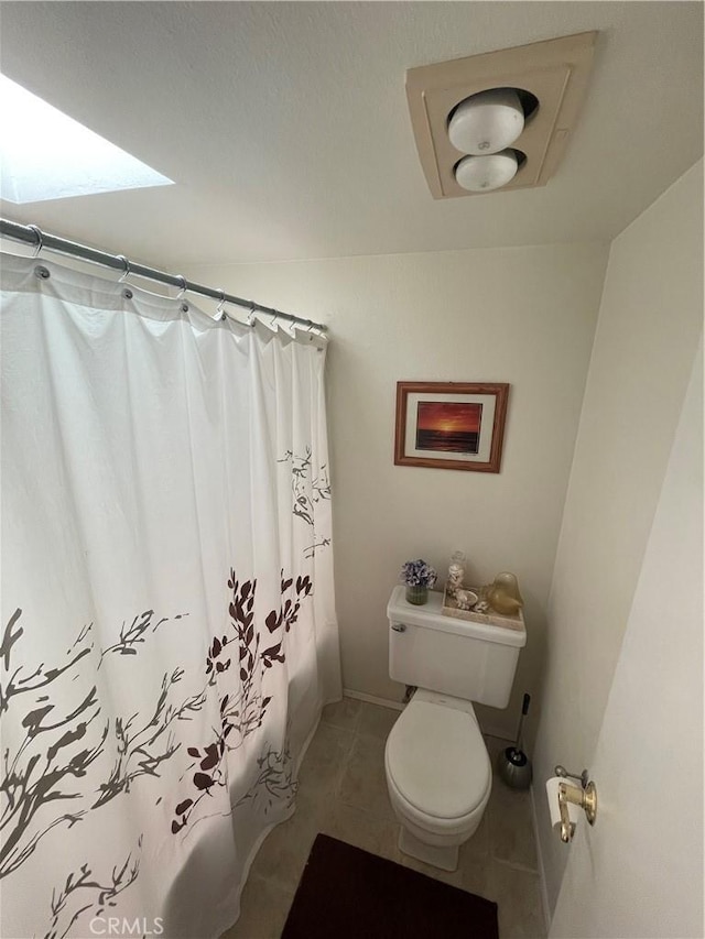 bathroom with tile patterned floors, shower / bathtub combination with curtain, and toilet