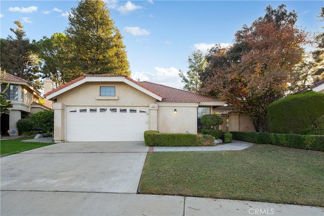 view of front of property with a front yard and a garage