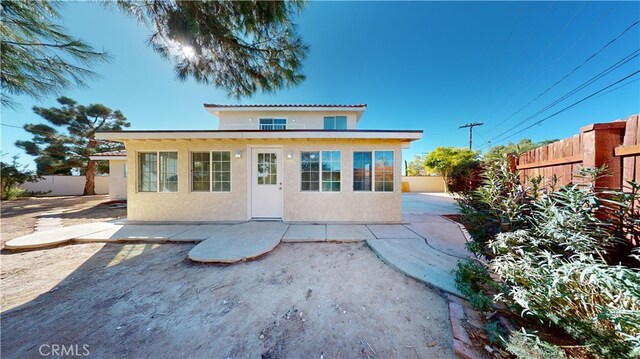 back of property with a patio