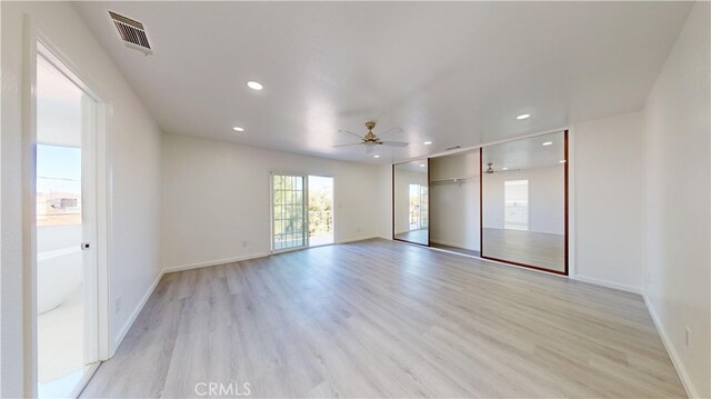 unfurnished room featuring light hardwood / wood-style flooring and ceiling fan