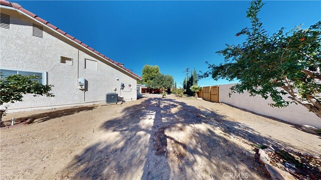 view of side of home with central AC