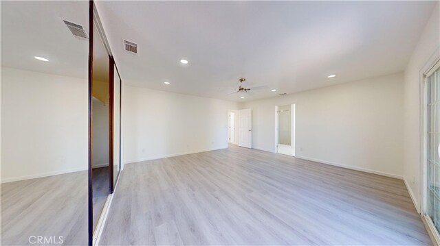 unfurnished room with ceiling fan and light hardwood / wood-style flooring