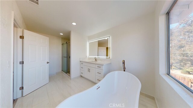 bathroom with plus walk in shower and vanity