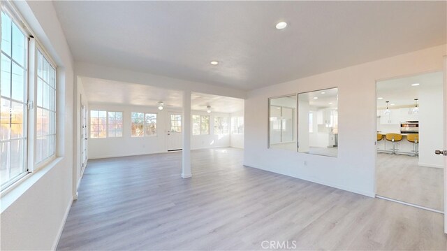 empty room featuring light wood-type flooring and ceiling fan