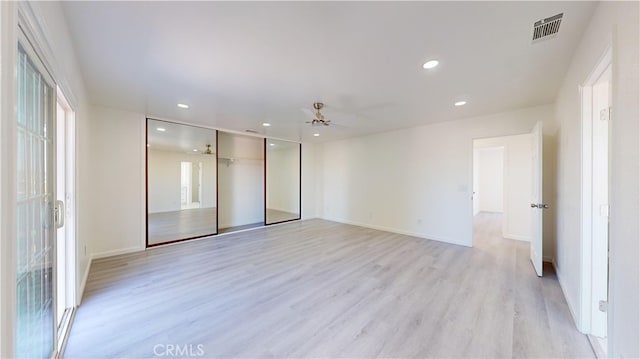 spare room with light hardwood / wood-style flooring and ceiling fan