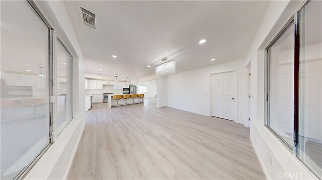 unfurnished living room with light hardwood / wood-style flooring